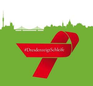 Beitrag zur Spendenaktion für die AIDS Hilfe Dresden. Auf der oberen Hälfte sieht man in grün die Skyline von Dresden und darunter ist eine große, rote Schleife platziert mit dem Text "#DresdenzeigtSchleife"
